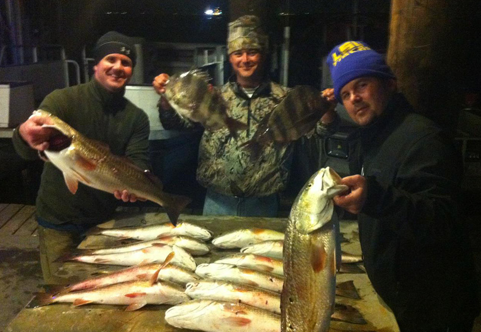 Beau Beaullieu and his brothers show the fish they caught together.